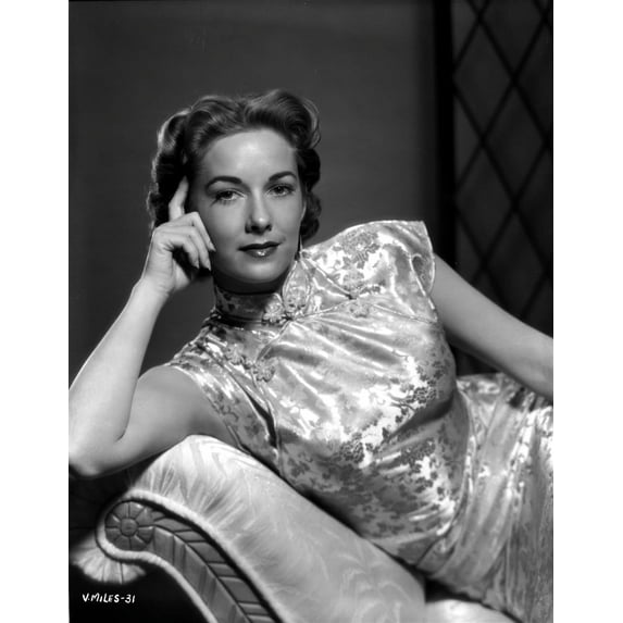 Vera Miles laying on a chaise lounger wearing oriental dress, with head propped into her hand Photo Print (24 x 30)