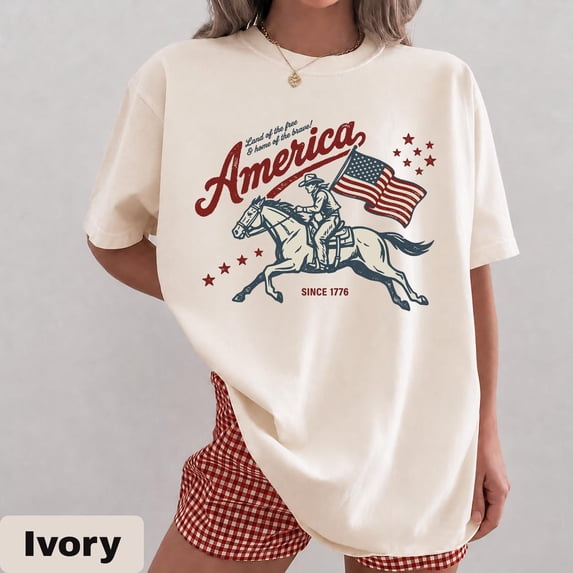 VibeNest Studio Unisex America Land of the Free Since 1776 Cowboy Horse Western Patriotic Graphic T-Shirt