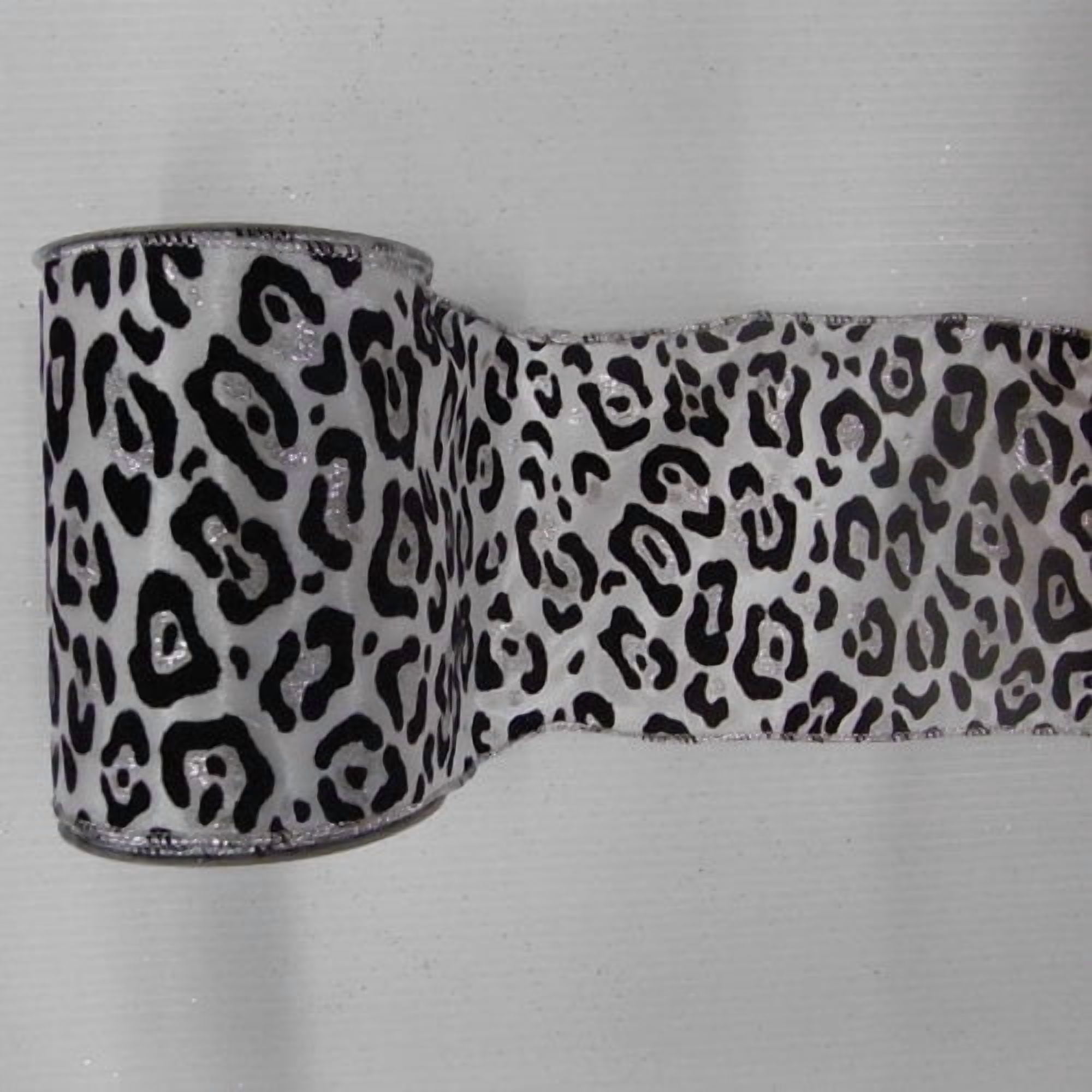 Vickerman 2.5" White Christmas Ribbon with Black Velvet Leopard Spots. 2.5" x 10 Yards in Length Wire Edged to allow Bending and Shaping.