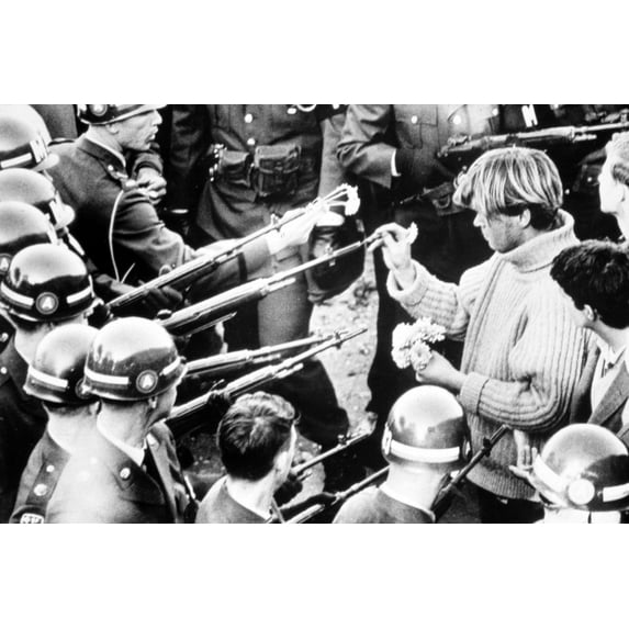 Vietnam War Protestor Puts Flowers Into The Barrels Of Soldiers' Rifles History (36 x 24)