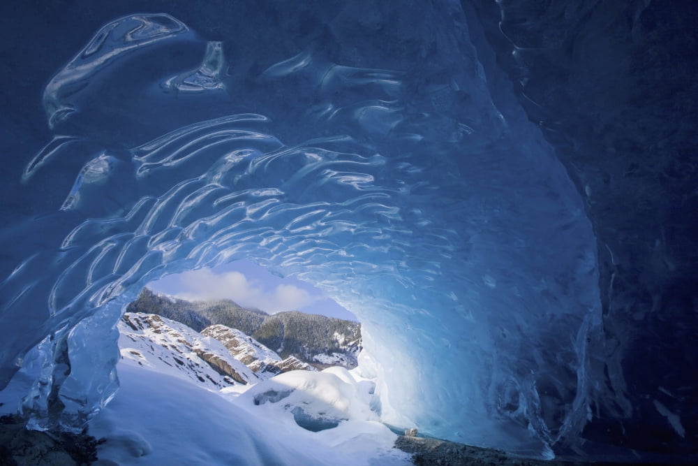 View From Inside An Ice Cave Looking Outward At The Snowcovered Landscape Mendenhall Glacier Near Juneau In Southeast Alaska Winter Canvas Art - John Hyde Design Pics (38 x 24)