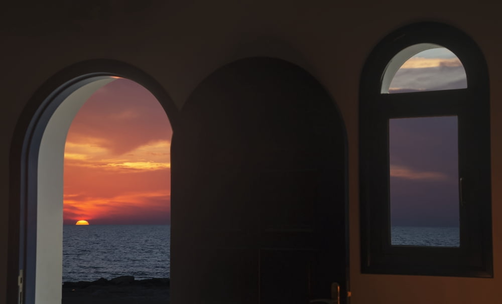 View of a colourful dramatic sunset over the ocean through an arched doorway Paphos Cyprus Canvas Art - John Short Design Pics (20 x 12)