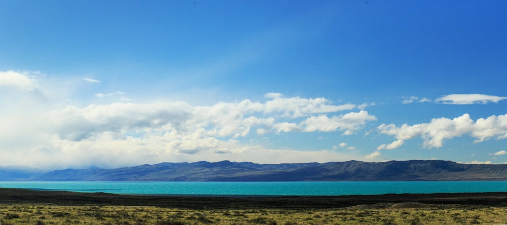 View of lake with mountains in background Lago Argentino Santa Cruz Province Patagonia Argentina Canvas Art - Panoramic Images (14 x 30)