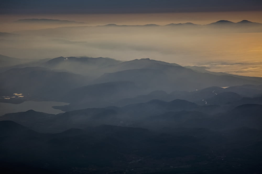View of mountains and clouds at sunset along the coastline Greece Canvas Art - Reynold Mainse Design Pics (38 x 24)