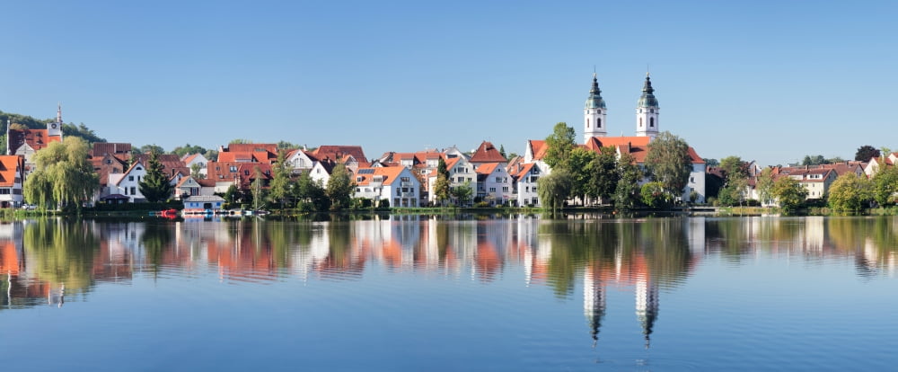 View of the Stadtsee lake and Collegiate Church of St Peter Bad Waldsee Upper Swabia Baden-Wurttemberg Germany Canvas Art - Panoramic Images (27 x 9)