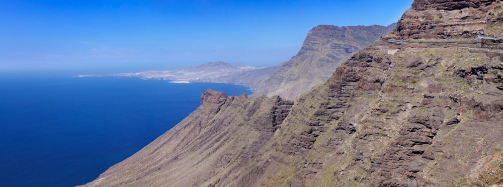 View of the steep coast Anden Verde Puerto De Las Nieves Roque Faneque Gran Canaria Spain Canvas Art - Panoramic Images (27 x 9)