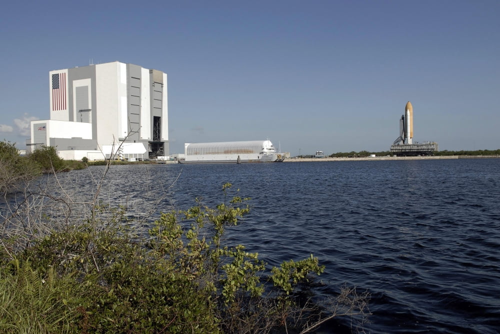 Viewed across the basin Space Shuttle Atlantis crawls toward the launch pad Canvas Art - Stocktrek Images (34 x 23)
