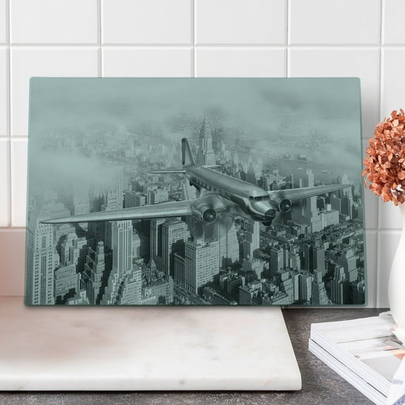 Vintage Cutting Board, Nostalgic Dated Plane Flying over Skyscrapers in New York City Urban Life, Decorative Tempered Glass Cutting and Serving Board, Large Size, Black and White, by Ambesonne