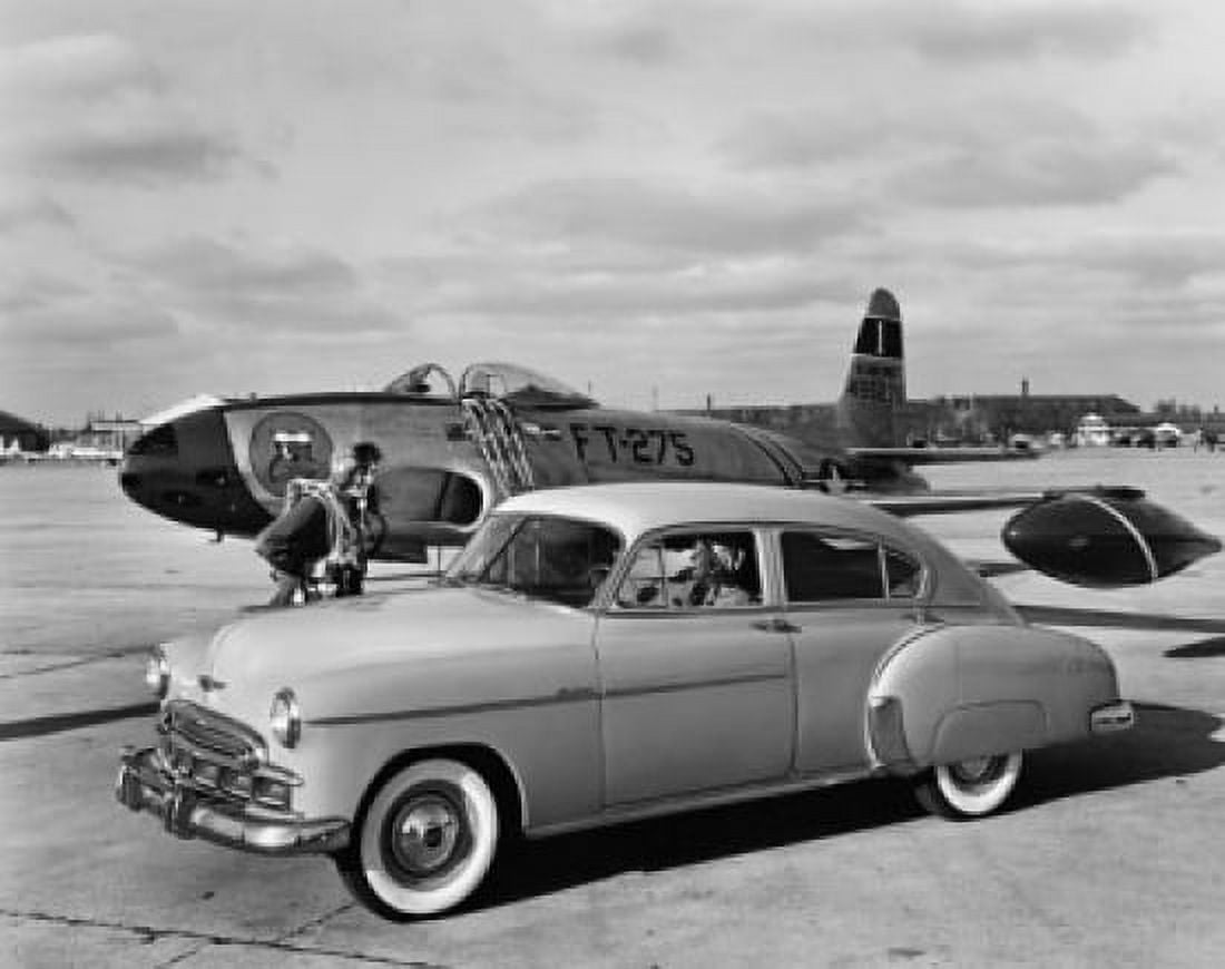 Vintage car near an airplane on a runway Canvas Art - (18 x 24)