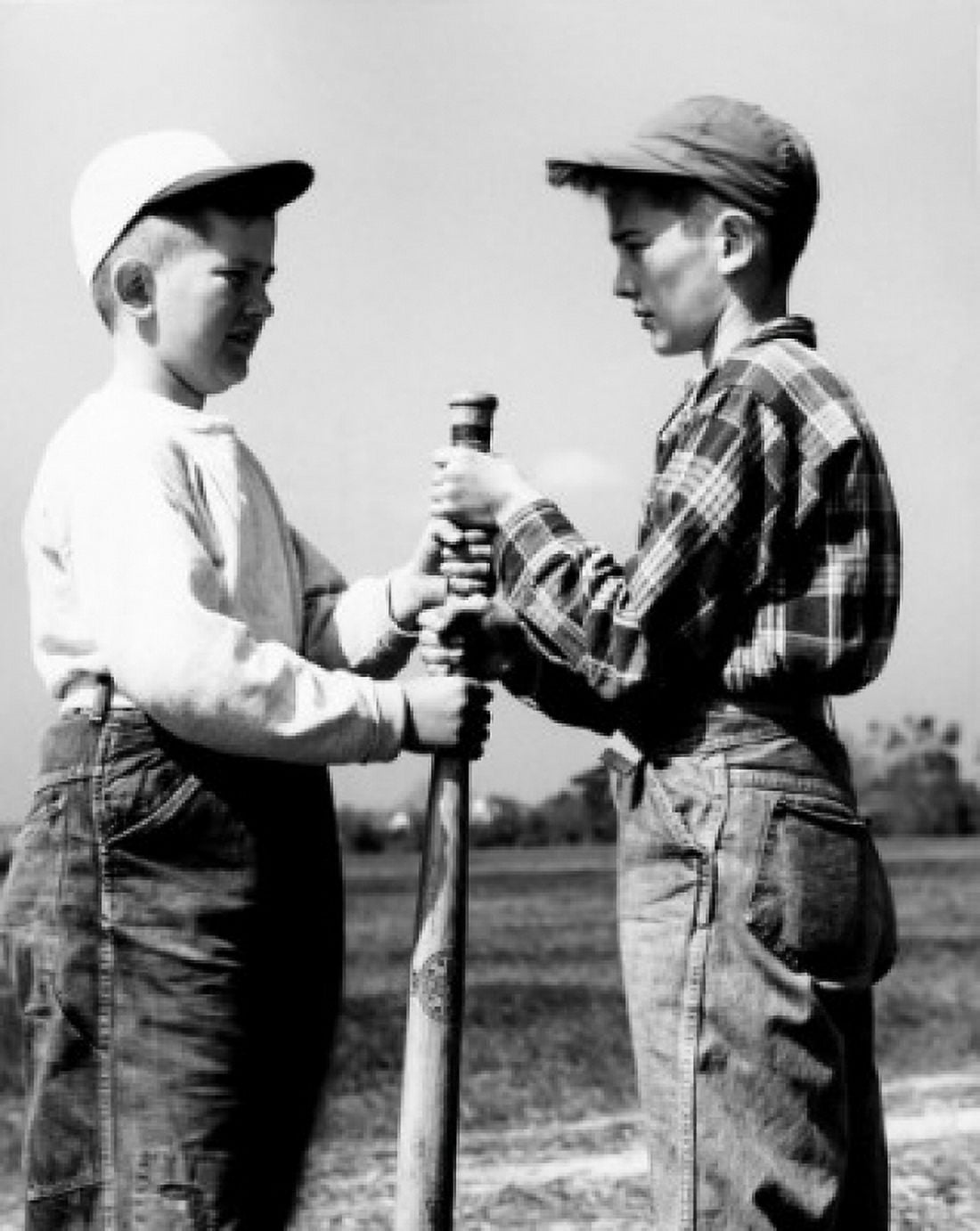 Vintage photograph of two boys wearing baseball caps gripping baseball club Canvas Art - (18 x 24)