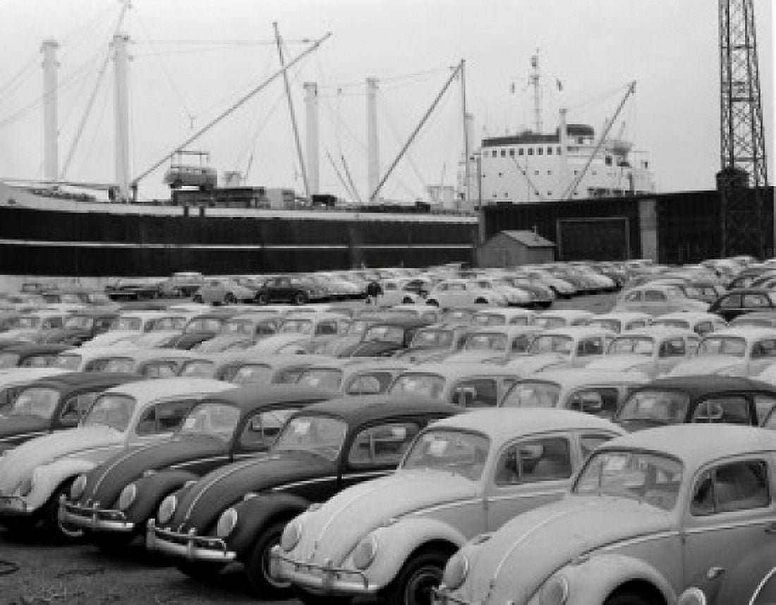 Volkswagen vans in parking lot with nautical vessel in background Canvas Art - (24 x 36)