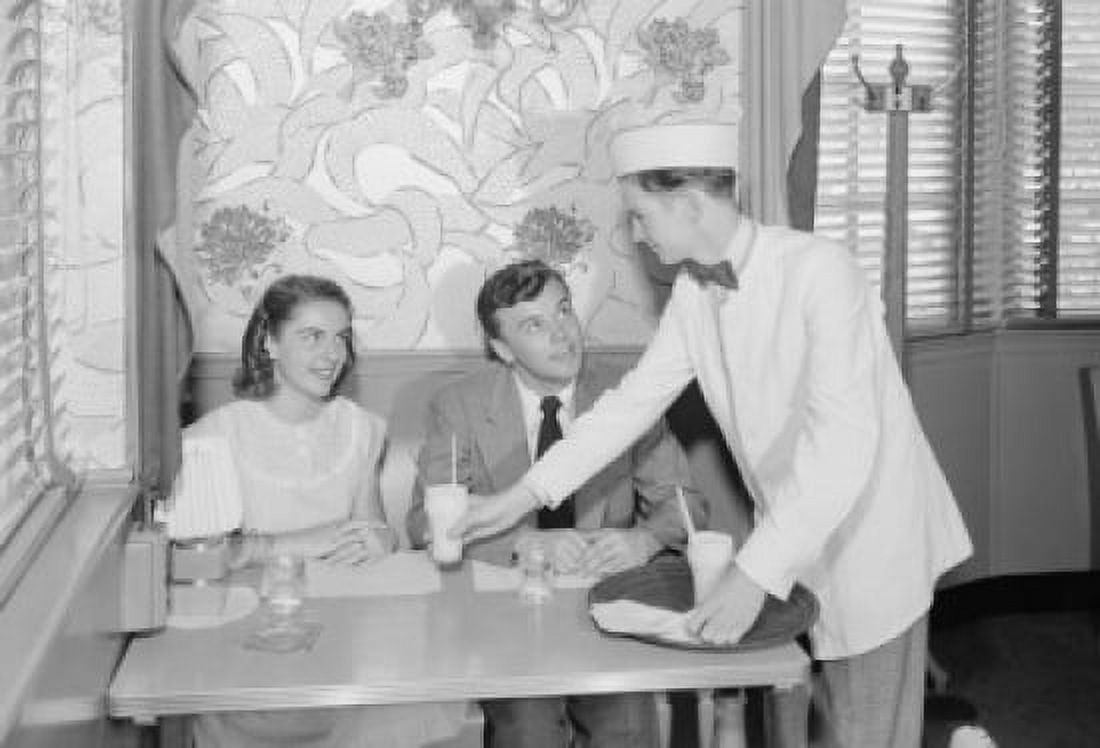 Waiter serving young couple in cafe Canvas Art - (24 x 36)