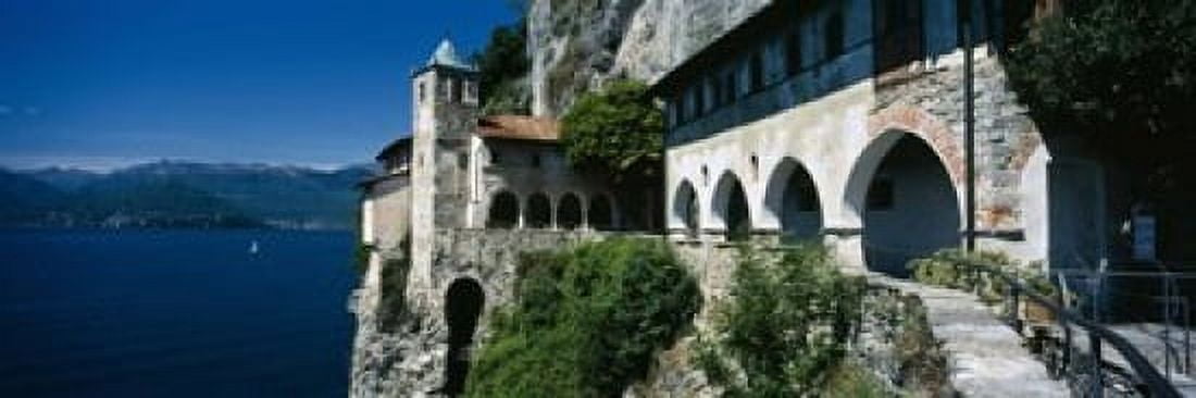 Walkway along a building at a lake Santa Caterina del Sasso Lake Maggiore Piedmont Italy Canvas Art - Panoramic Images (18 x 6)
