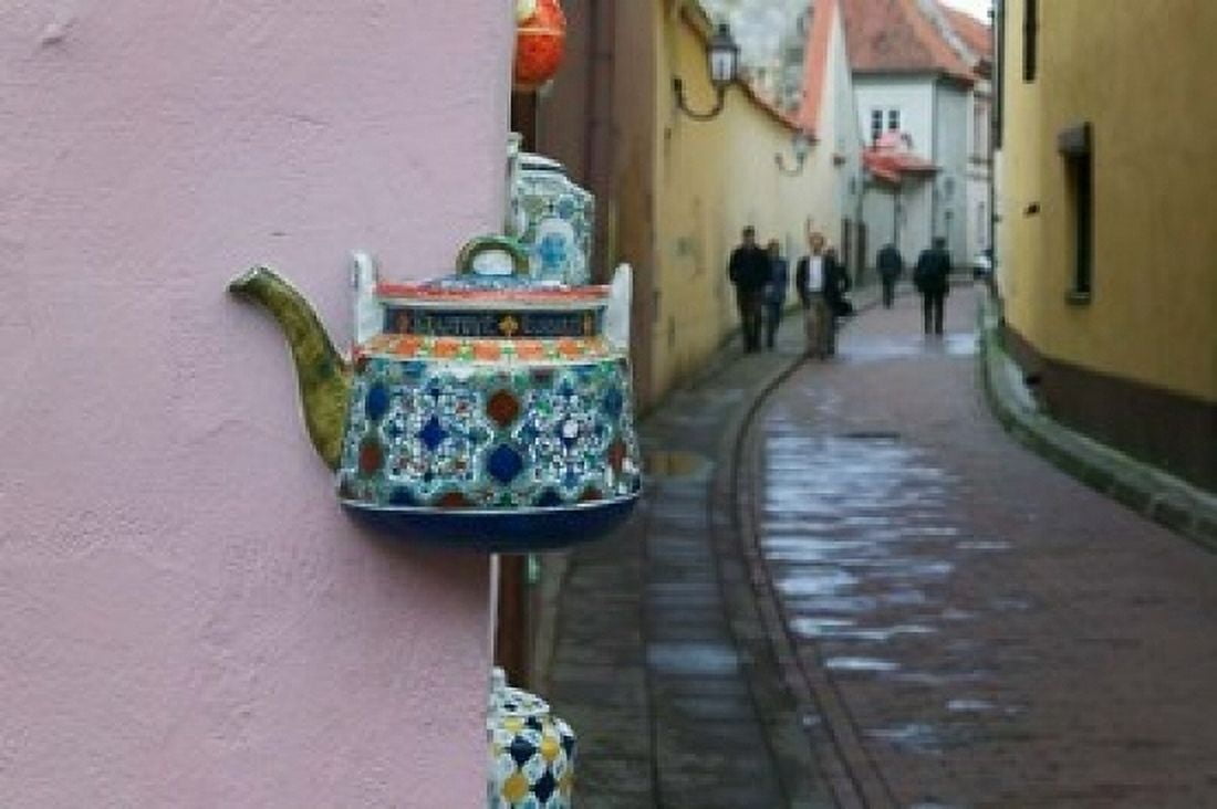 Wall Decorated with Teapot and Cobbled Street in the Old Town Vilnius Lithuania II Canvas Art - Keren Su DanitaDelimont (24 x 15)