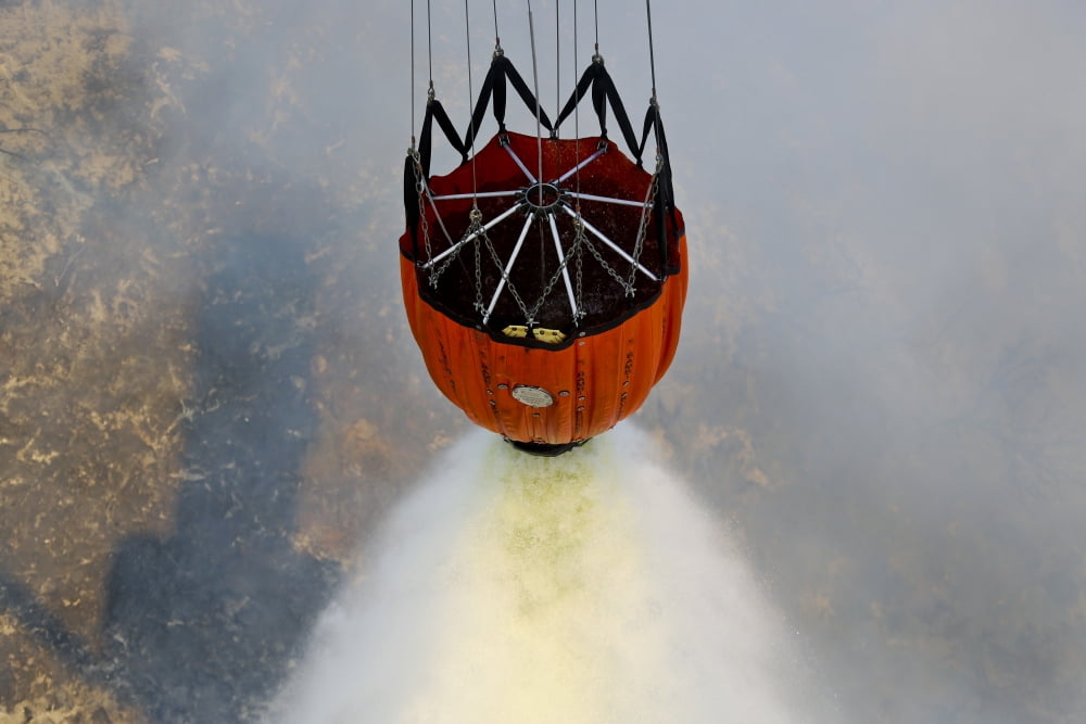 Water drops are performed using Bambi Buckets to assist the wildfires in California Canvas Art - Stocktrek Images (34 x 23)