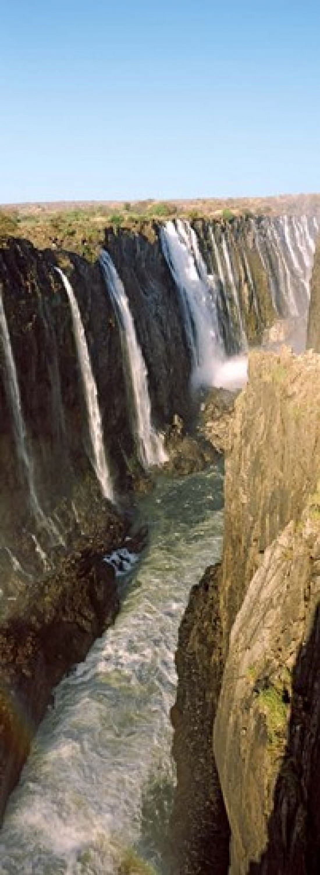 Water falling through rocks in a river Victoria Falls Zimbabwe Canvas Art - Panoramic Images (18 x 7)