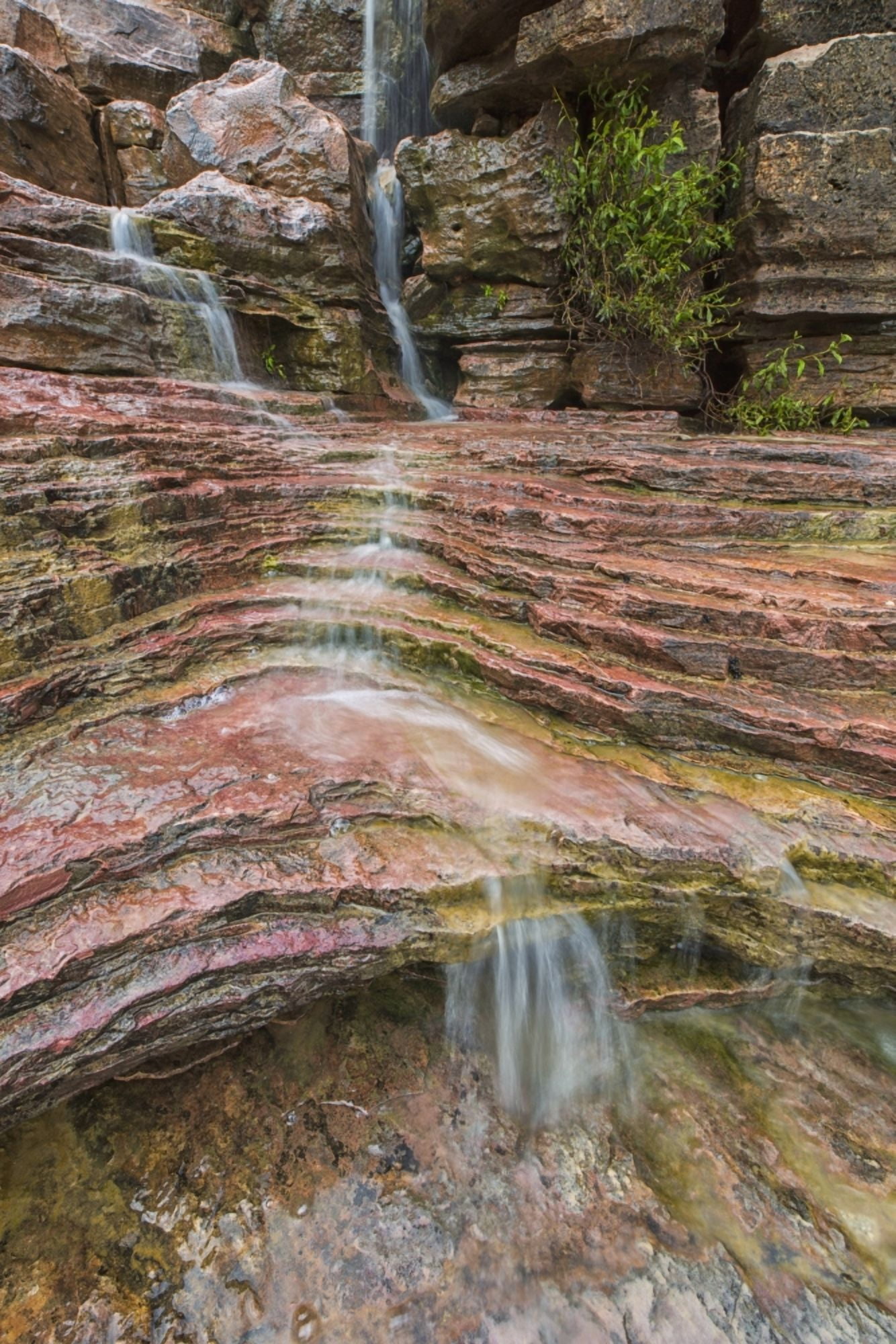 Water flows over a very colourful waterfall in the heart of Toro Toro National Park Bolivia Canvas Art - Robert Postma Design Pics (12 x 19)