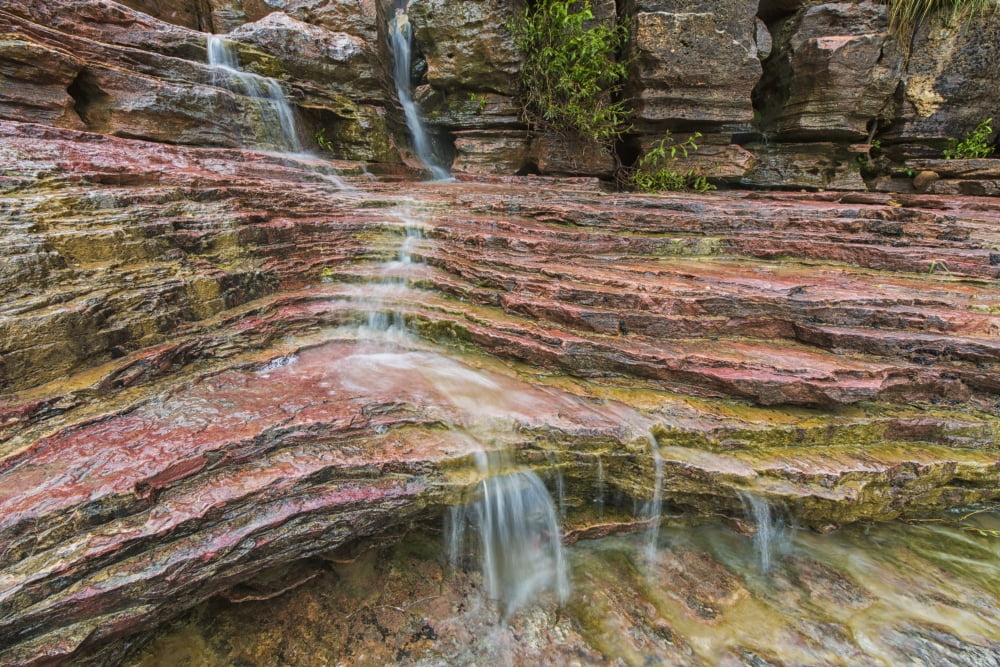 Water flows over a very colourful waterfall in the heart of Toro Toro National Park Bolivia Canvas Art - Robert Postma Design Pics (19 x 12)