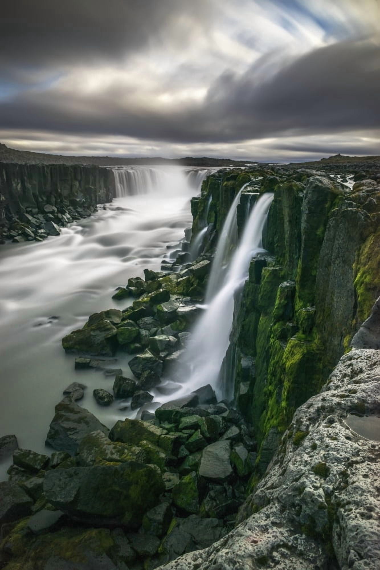 Waterfall flowing over moss covered cliffs Selfoss Iceland Canvas Art - Robert Postma Design Pics (12 x 19)