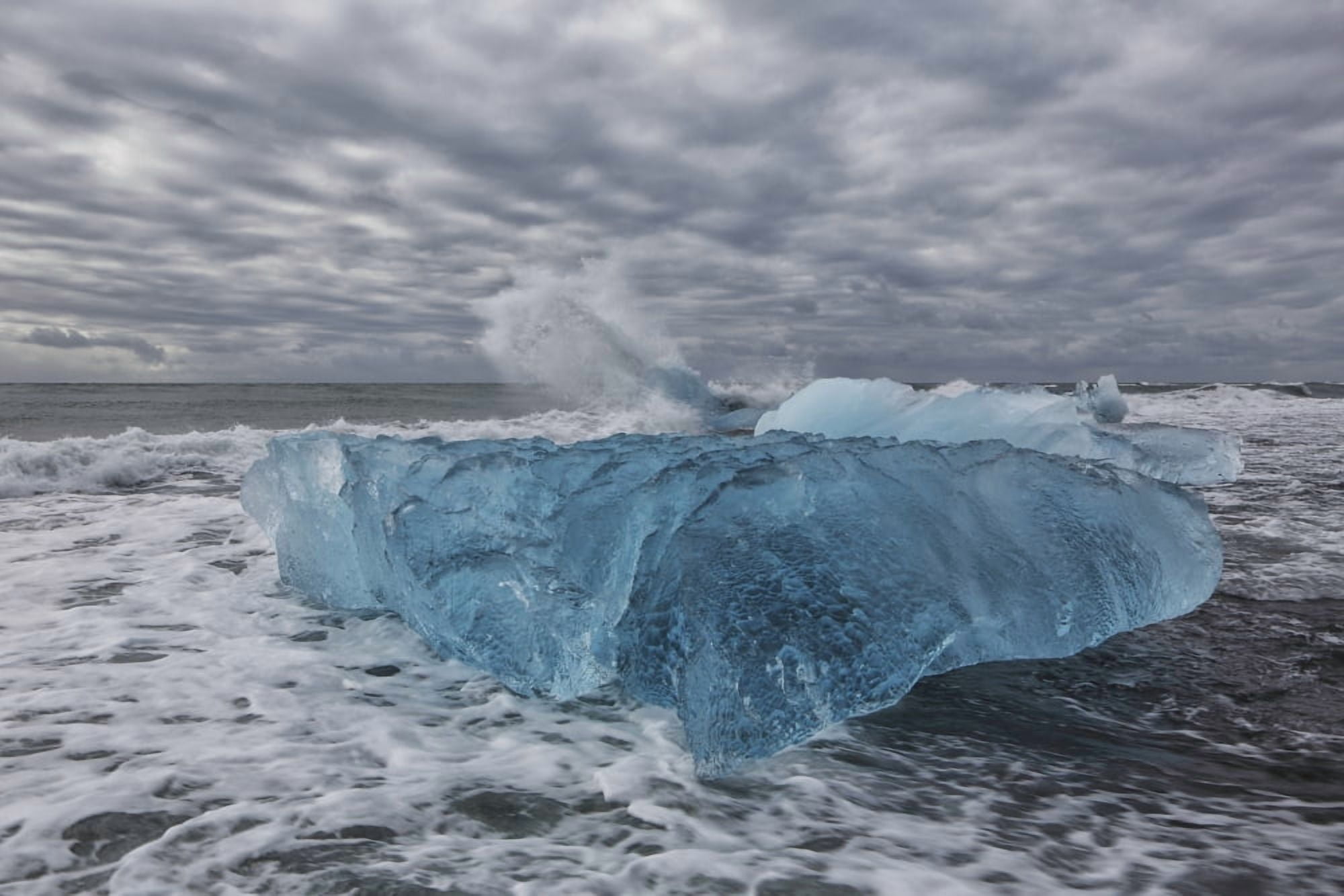 Waves from the atlantic ocean crash into ice calf from breioamerkurjokull a glacial tongue of the vatnajokull ice cap iceland Canvas Art - Robert Postma Design Pics (38 x 24)