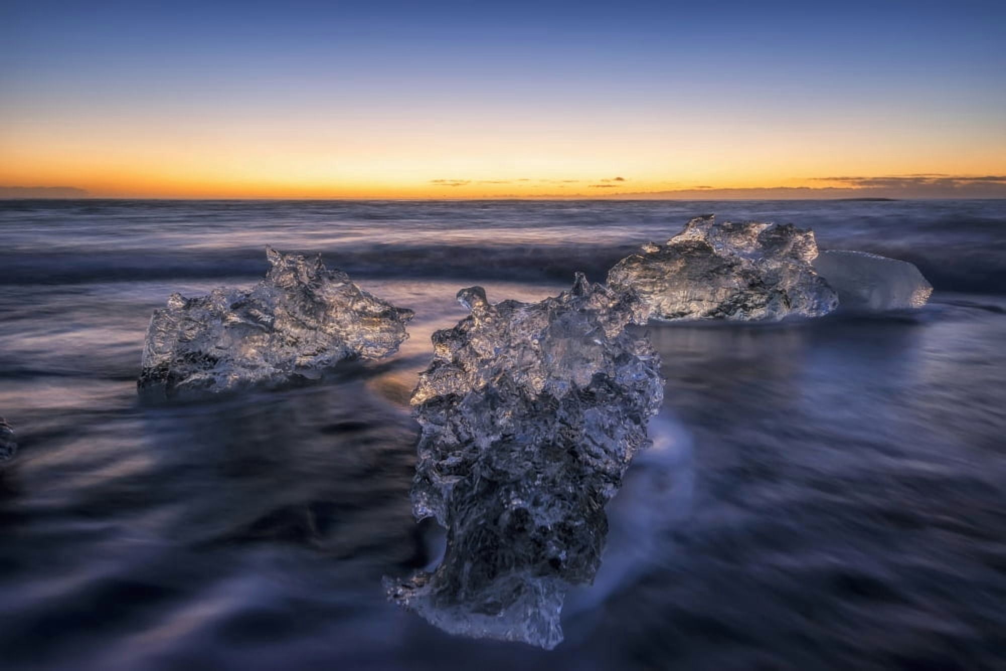 Waves break around icebergs on the southern shore of Iceland near the glacial lagoon of Jokursarlon Iceland Canvas Art - Robert Postma Design Pics (19 x 12)