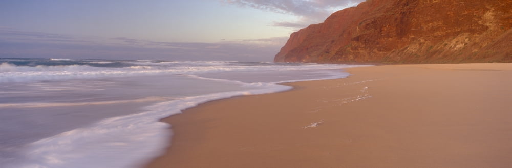 Waves breaking on sandy Barking Sands beach with the Na Pali coast in the background in the evening Kauai Hawaii Canvas Art - Panoramic Images (36 x 12)