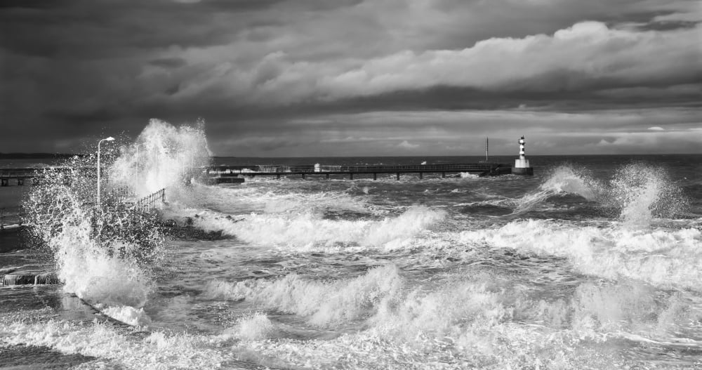 Waves crashing along the coast with a small lighthouse at the end of a pier Amble Northumberland England Canvas Art - John Short Design Pics (21 x 11)