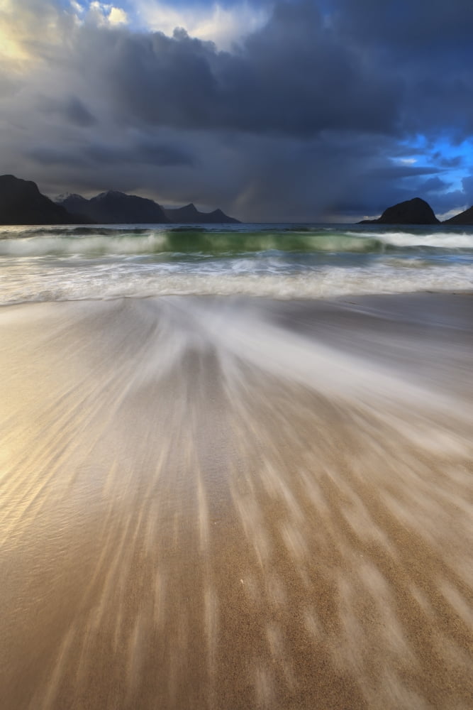Waves washing back to sea on Haukland Beach Lofoten Norway Canvas Art - Arild HeitmannStocktrek Images (12 x 18)