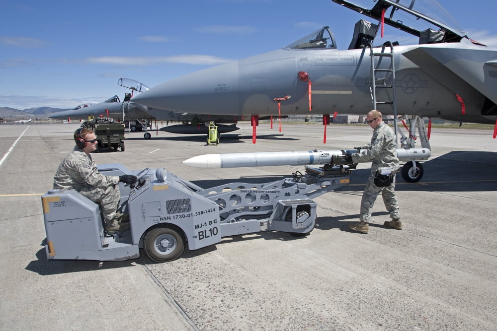 Weapons crew prepare to load an AIM-120 missile on an F-15 Eagle Canvas Art - HIGH-G ProductionsStocktrek Images (18 x 12)