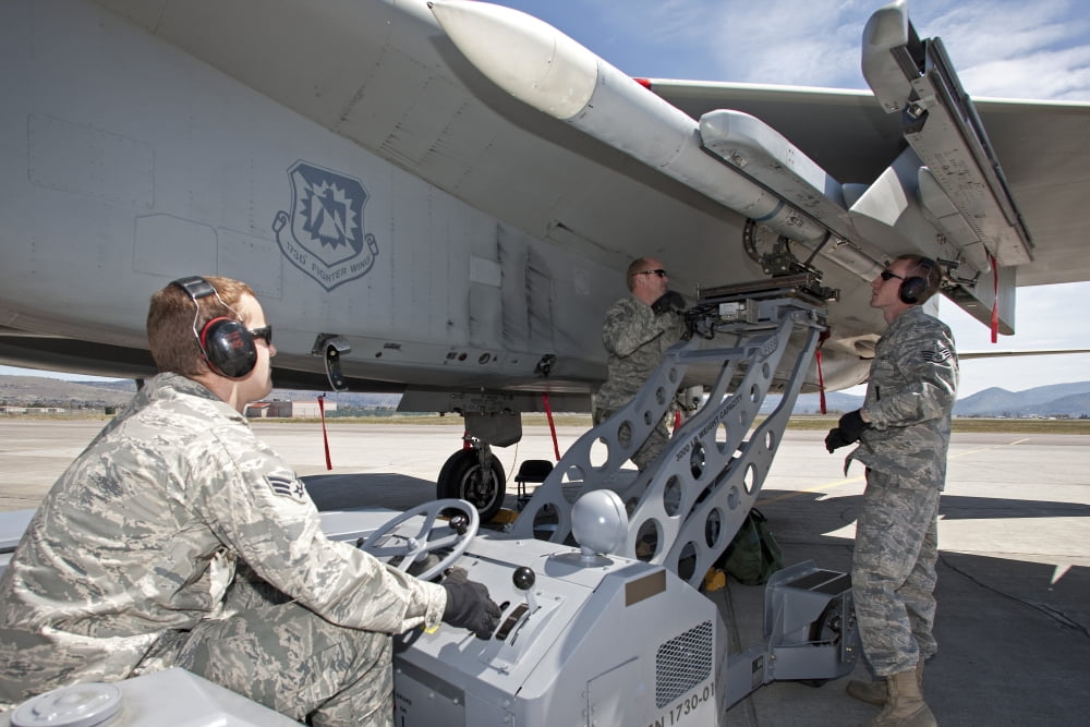 Weapons crew prepare to load an AIM-120 missile on an F-15 Eagle Canvas Art - HIGH-G ProductionsStocktrek Images (35 x 23)
