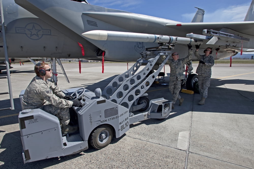 Weapons crew prepare to load an AIM-120 missile on an F-15 Eagle Canvas Art - HIGH-G ProductionsStocktrek Images (35 x 23)