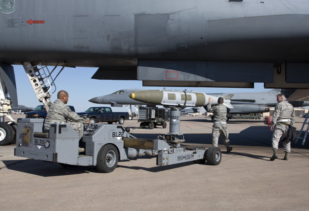 Weapons loaders prepare to load a GBU-31 JDAM onto a B-1 bomber Canvas Art - HIGH-G ProductionsStocktrek Images (18 x 12)