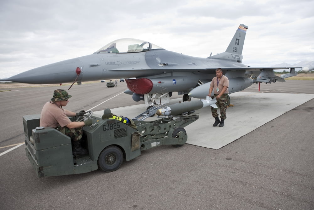 Weapons loaders prepare to load a GBU-38 JDAM on an F-16 Canvas Art - HIGH-G ProductionsStocktrek Images (18 x 12)