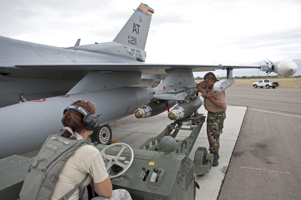 Weapons loaders prepare to load a GBU-38 JDAM on an F-16 Canvas Art - HIGH-G ProductionsStocktrek Images (35 x 23)