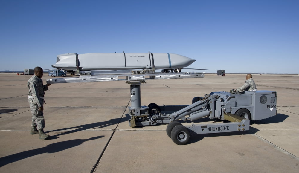 Weapons loaders prepare to load an AGM-158 JASSM onto a B-1 bomber Canvas Art - HIGH-G ProductionsStocktrek Images (19 x 11)