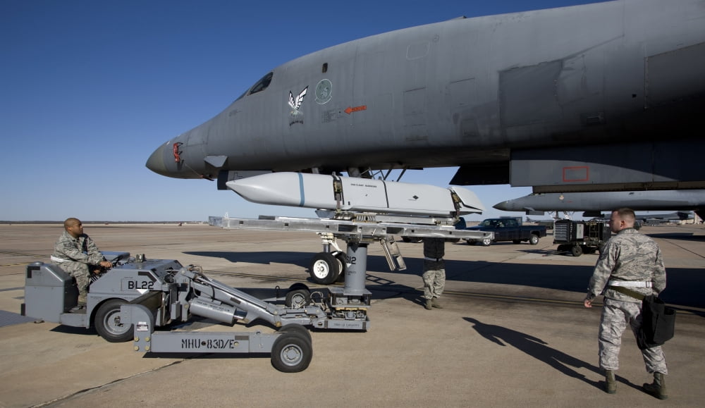 Weapons loaders prepare to load an AGM-158 JASSM onto a B-1 bomber Canvas Art - HIGH-G ProductionsStocktrek Images (19 x 11)