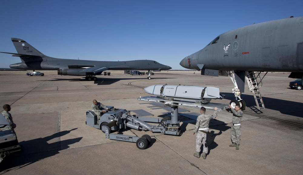 Weapons loaders prepare to load an AGM-158 JASSM onto a B-1 bomber Canvas Art - HIGH-G ProductionsStocktrek Images (19 x 11)