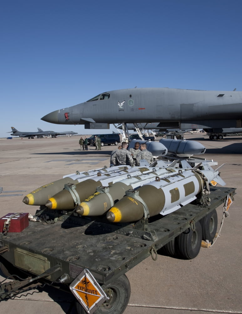 Weapons loaders prepare to load armament onto a B-1 bomber Canvas Art - HIGH-G ProductionsStocktrek Images (25 x 33)