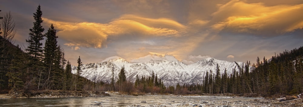 The Wheaton River In Early Winter With The Clouds Lit By Sunset Light Snow Covered Mountains Seen In The Distance Located Outside Of Whitehorse Yukon Canvas Art - Robert Postma Design Pics (44 x 15)