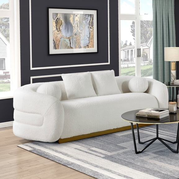 White Upholstered Sofa with Gold Accent Base and Pillows