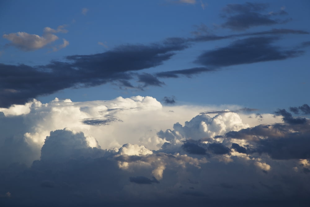 White and dark clouds in a blue sky Kings Beach Queensland Australia Canvas Art - John Short Design Pics (19 x 12)