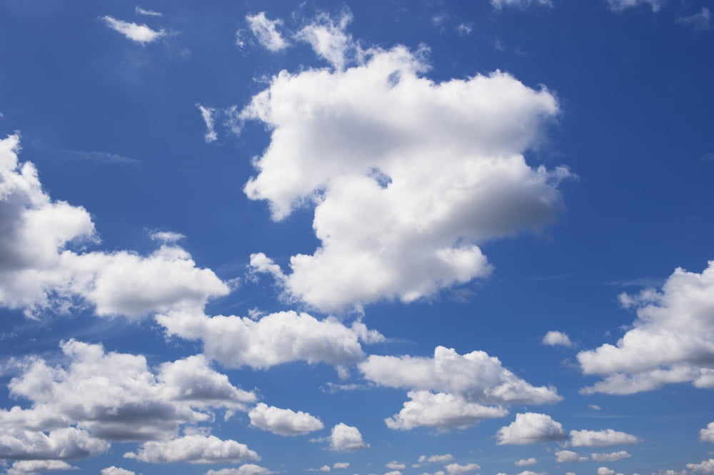 White cumulus clouds in a blue sky United Kingdom Canvas Art - Wayne Hutchinson Design Pics (19 x 12)