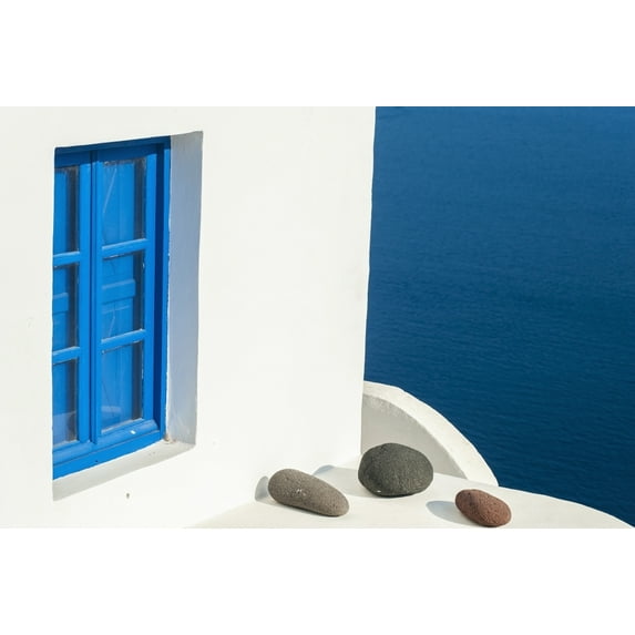 Whitewash building with blue trimmed window along the Aegean sea; Oia Santorini Greece Poster Print