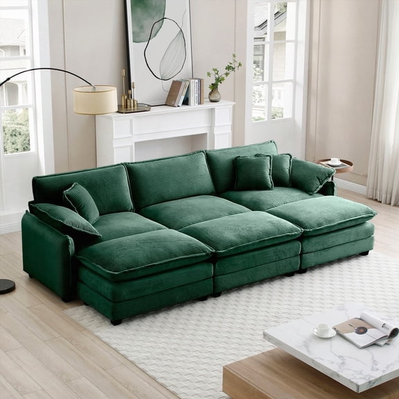 Green corduroy fabric oversized modular sofa featuring 3 ottomans that double as sleeper beds & 3 footstools for ultimate comfort and style.