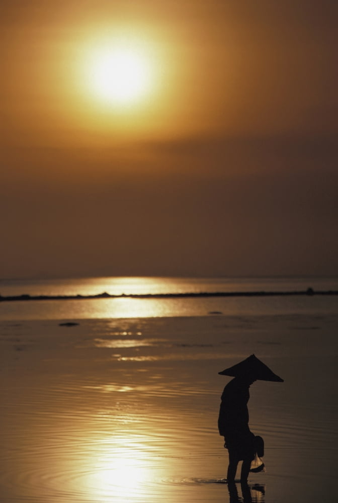 Woman In Conical Hat Collecting Shell Fish At Sunset Canvas Art - Martin Stolworthy Design Pics (12 x 18)