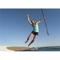thumbnail image 1 of A Woman Jumps Into The Water Off A Surf Board While Holding Her Paddle In Front of Dos Mares Beach - Tarifa, Cadiz, Andalusia, Spain Poster Print, 17 x 12, 1 of 1