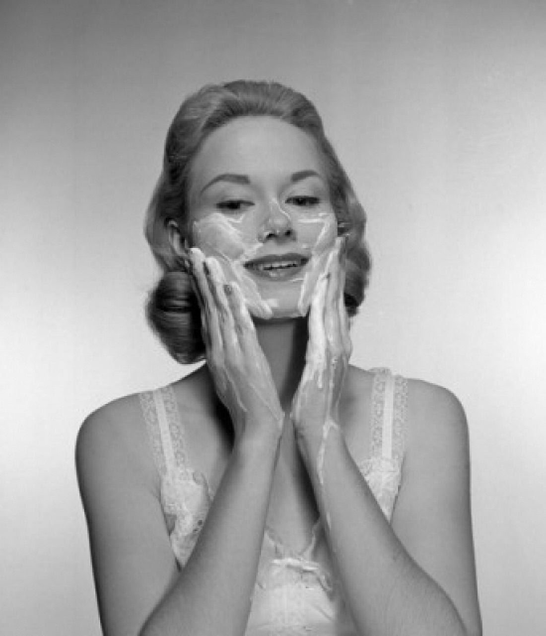 Woman applying face mask Canvas Art - (24 x 36)