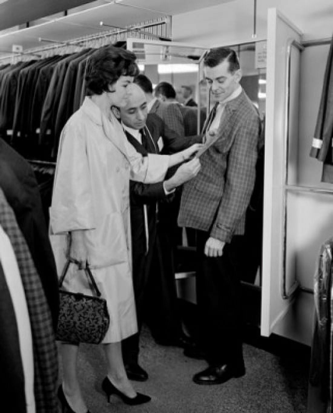 Woman assisting man trying on suit in shop Canvas Art - (24 x 36)