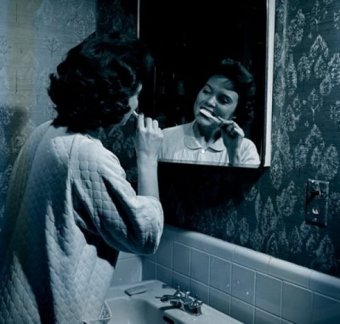 Woman brushing teeth in front of mirror Canvas Art - (24 x 36)