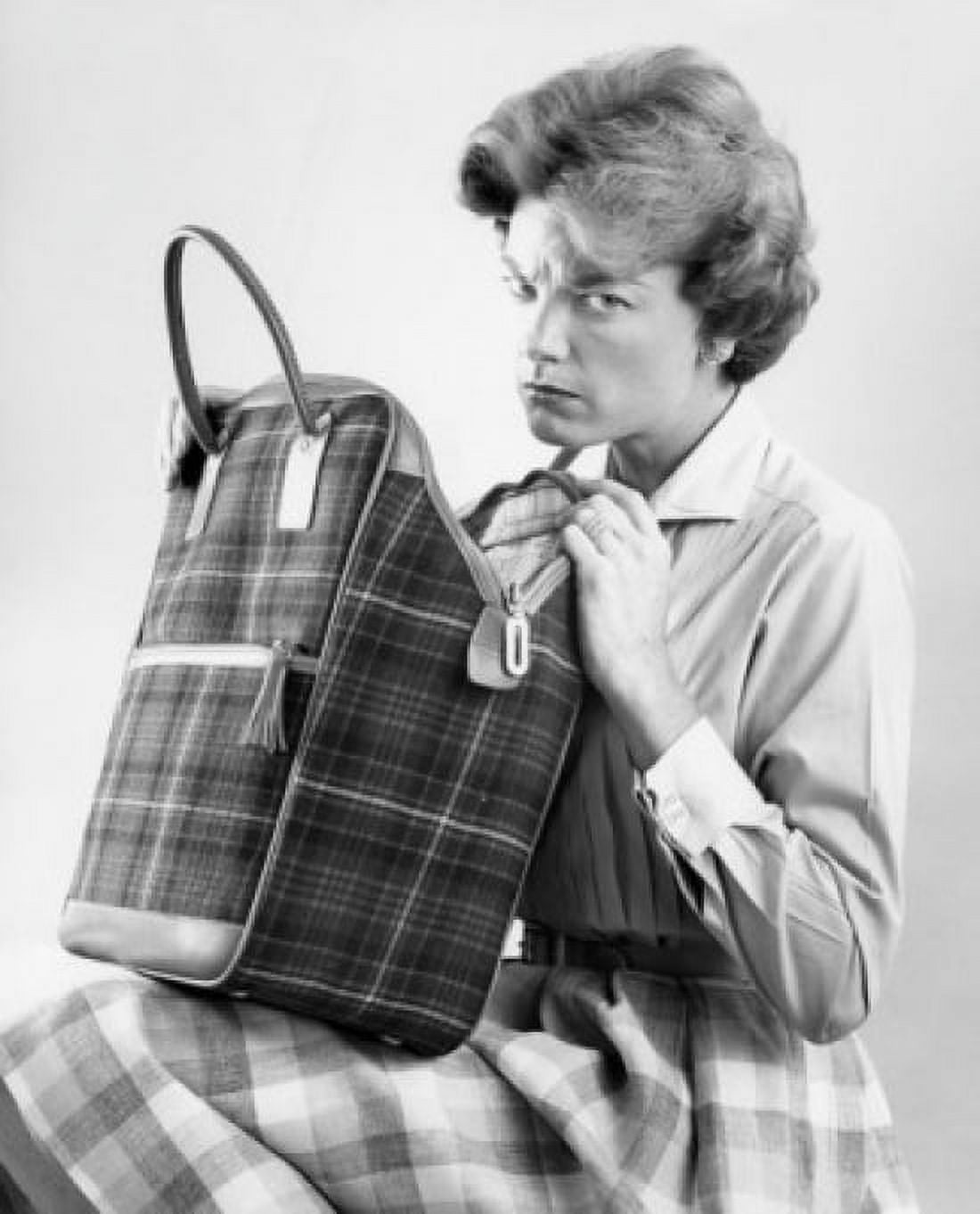 Woman checking bag with frowning forehead Canvas Art - (18 x 24)